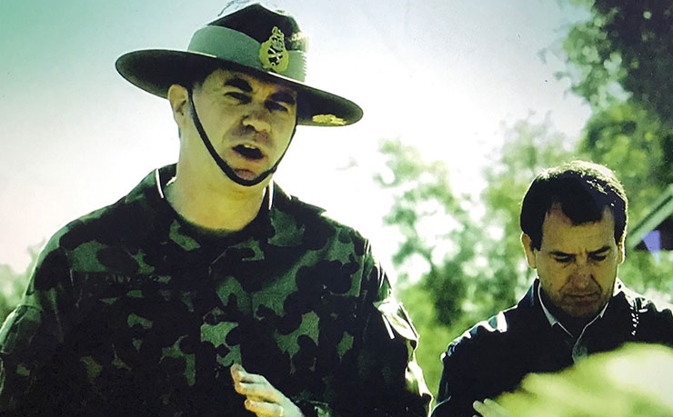 Army officials and Minister Mal Brough address community members in Mutitjulu, as part of the Northern Territory Emergency Response on June 21, 2007. The image is a screen cap from John Pilger's film Utopia.