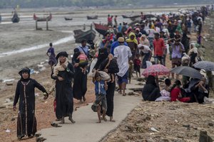 Rohingya Muslims, who crossed over from Myanmar into Bangladesh, walk towards the nearest refugee camp at Teknaf, Bangladesh, Saturday, Sept. 16, 2017.