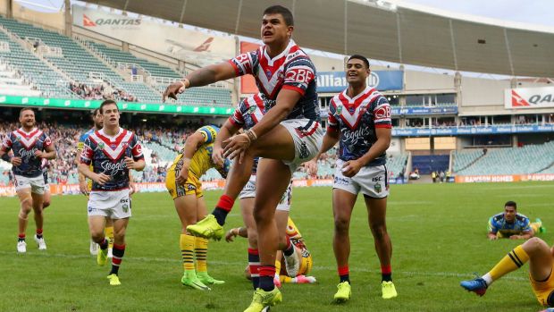 Blitz: Latrell Mitchell enjoys the spoils of an early score.