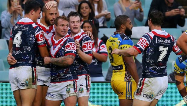 Field day: Blake Ferguson is mobbed after scoring another try.