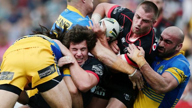 Thwarted: Kieran Foran gets caught in a scrum of bodies.