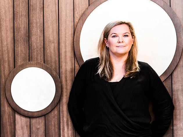 Microsoft managing director, Pip Marlow, standing in front of a wood-paneled wall