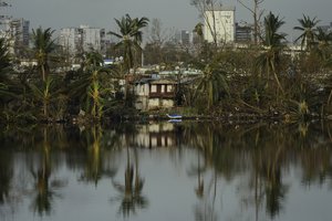 A view of Buena Vista community  from the Teodoro Moscoso bridge on the fourth day after the impact of Maria, a Category 5 hurricane that crossed the island, in San Juan, Puerto Rico, Sunday, September 24, 2017. Shortly after the passing of the hurricane all communications collapsed all over the US Territory. (AP Photo/Carlos Giusti)