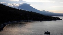 The sun sets behind Mount Agung in Bali.