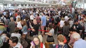 Crowds gathered at Sydney Airport after delays stemming from a "technical issue".