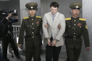 American student Otto Warmbier, center, is escorted at the Supreme Court in Pyongyang, North Korea, Wednesday, March 16, 2016.