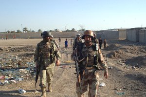 File - Iraqi army soldiers from 1st Brigade, 9th Iraqi Army Division patrol in the Zafaraniyah area of East Baghdad, Iraq