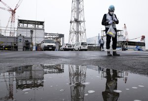 A journalist uses a geiger counter during a media tour to the tsunami-crippled Fukushima Dai-ichi nuclear power plant of the Tokyo Electric Power Co. (TEPCO) in Okuma town, Fukushima prefecture, Japan, Thursday, Feb. 23, 2017.