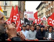 Fabio Zerbini with microphone, addressing a workers' demonstration.