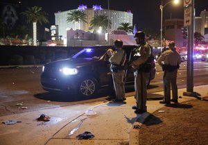 Las Vegas Police stand at the scene of a shooting along the Las Vegas Strip, Monday, Oct. 2, 2017, in Las Vegas.