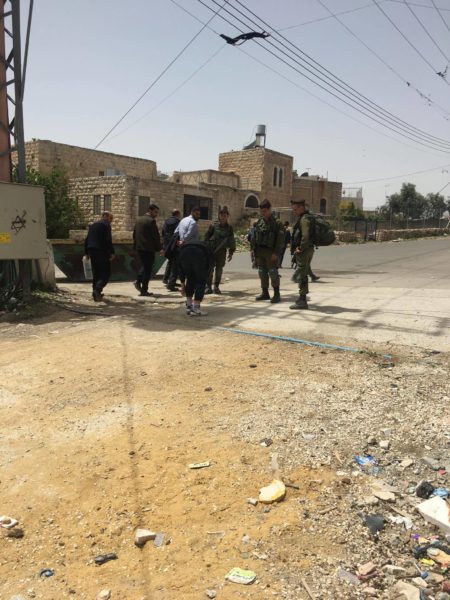 A Palestinian is subject to a body check by Israeli soldiers outside Mutannabi boys’ school, H2.