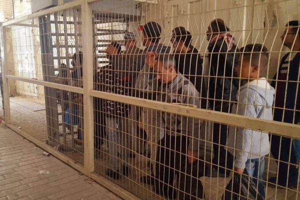 Palestinian residents are made to wait outside the Ibrahimi Mosque checkpoint following its reopening on Friday.