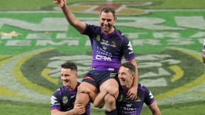 Immortals-in-waiting: Cameron Smith is chaired off by Billy Slater and Cooper Cronk.