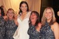 Six of the best: Debbie Speranza, to the left of bride Julia Mammone, and the others wearing the same dress share a laugh.