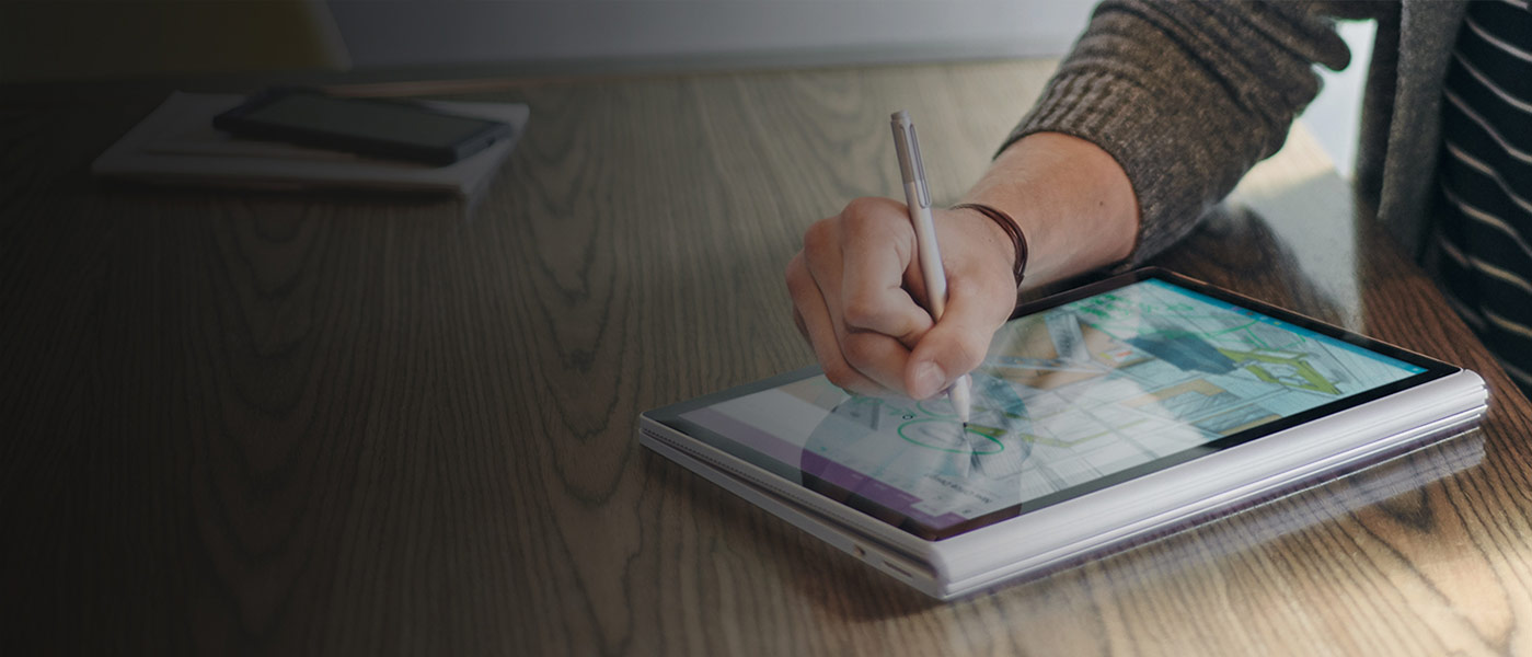 Person using stylus to draw on folded-open Surface Book