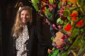 Artist Kate Rohde with her floral installation at Heronswood.