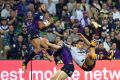 Josh Addo-Carr (left) and Curtis Scott of the Storm and Darius Boyd of the Broncos contest during the first NRL ...