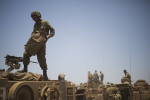 Israeli soldiers stand on top of armored military vehicles during training exercises in the Israeli-occupied Golan Heights, near the border with Syria, Wednesday, June 17, 2015.