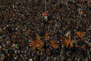 Protesters with ''esteladas'' or Catalonia independence flags pack the University square during a one-day strike in Barcelona, Spain, Tuesday Oct. 3, 2017.