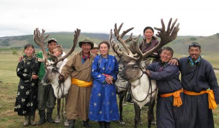 Tsaatan guides and families posing with reindeer