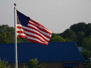 The Flag blowing in the wind with the field house in the background, Boyd-Buchanan School, Chattanooga, Tennessee