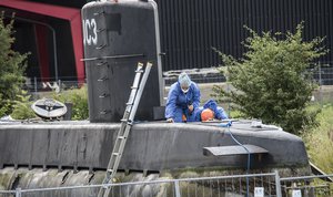 FILE - This is a Monday Aug. 14, 2017 file photo of police technicians on board the home-made submarine UC3 Nautilus on a pier in Copenhagen harbour, Denmark to conduct forensic probes in connection with a missing journalist investigation.