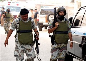  Saudi policemen walk from the scene following a shooting incident Tuesday, Nov. 9, 2004 in Jiddah, Saudi Arabia. Saudi police killed a suspected militant and arrested three others in possession of weapons and ammunition as part of the ongoing crackdown o