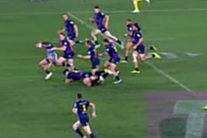 Pursued: Kyle Feldt is chased down by eight Storm defenders during the grand final.