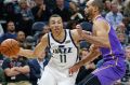 Australian Utah Jazz guard Dante Exum drives around Sydney Kings forward Perry Ellis.