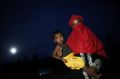 A Rohingya woman holds a child and stands for a photograph at Palangkhali refugee camp in Cox's Bazar, Bangladesh. 