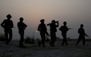 Indian army soldiers patrol near the highly militarized Line of Control dividing Kashmir between India and Pakistan, in Pallanwal sector, about 75 kilometers from Jammu, India, Tuesday, Oct. 4, 2016.