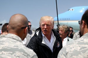 President Donald J. Trump shakes hands with service members during a visit to Carolina, Puerto Rico, Oct. 3, 2017