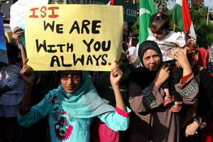 In this Friday, April 25, 2014 photo, supporters of a Pakistani religious group rally to support the Pakistan army and its Inter-Services Intelligence wing, ISI, in Lahore, Pakistan.