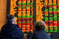 People looking at the stock price board at the ASX in Sydney.