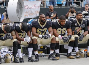 Many members of the New Orleans Saints protest against remarks made by President Trump by quietly sitting during the National Anthem before an NFL football game against the Carolina Panthers in Charlotte, N.C., Sunday, Sept. 24, 2017. The Saints won 34-13.