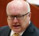 Attorney-General George Brandis will have the power to block legal action or appeal an injunction.