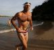 Mr Abbott competing in a charity swim in 2010, after which his budgie smugglers were auctioned on eBay.