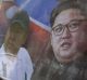 A sign shows images of Kim Jong-un, right, and his older brother Kim Jong-nam during a campaign to improve human rights ...