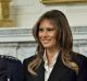 US President Donald Trump gives a thumbs up next to first lady Melania Trump during an official photograph with senior ...