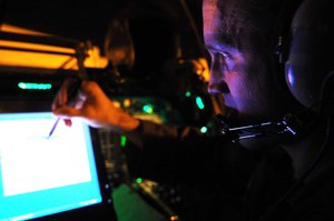 U.S. Air Force Maj. Chris Lovegren, a pilot with the 34th Bomb Squadron, operates the beyond line of sight system (BLOS) of a B-1B Lancer bomber during his preflight checklist at Ellsworth Air Force Base