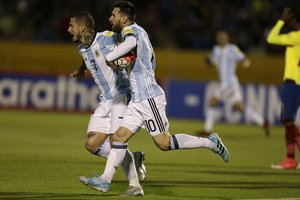 Argentina's Lionel Messi, center, runs with the ball with teammate Argentina's Dario Benedetto after scoring against Ecuador during their 2018 World Cup qualifying soccer match at the Atahualpa Olympic Stadium in Quito, Ecuador, Tuesday, Oct. 10, 2017.