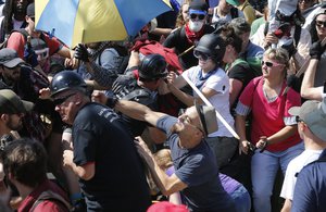 Alt Right demonstrators clash with  counter demonstrators at the entrance to Lee Park in Charlottesville, Va., Saturday, Aug. 12, 2017.