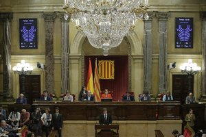 Catalan regional President Carles Puigdemont delivers his opening speech at the parliament in Barcelona, Spain, Tuesday, Oct. 10, 2017.