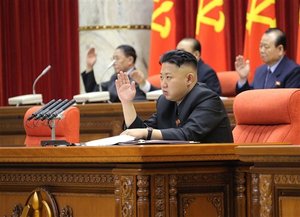 File - In this Sunday, March 31, 2013 photo released by the Korean Central News Agency (KCNA) and distributed in Tokyo Monday, April 1, 2013 by the Korea News Service, North Korean leader Kim Jong Un raises his hand with other officials to adopt a statement during a plenary meeting of the central committee of the ruling Workers' Party in Pyongyang, North Korea.