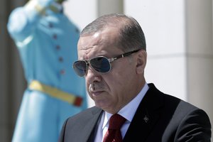 Turkey's President Recep Tayyip Erdogan walks before a welcome ceremony for Indonesian President Joko Widodo at the presidential palace in Ankara, Turkey, Thursday, Juy 6, 2017.