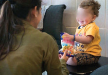 An IDF soldier comforts a Syrian child receiving humanitarian aid from Israel.