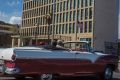 Tourists ride a classic convertible car on the Malecon beside the United States Embassy in Havana, Cuba.