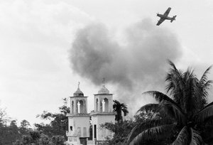 A South Vietnamese A-1 Skyraider flies over the twin steeples of a Buddhist pagoda in northeastern Saigon, June 13, 1968 as it drops napalm on suspected Viet Cong positions.