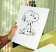 Charles Schulz displays a sketch of his beloved character "Snoopy" in his office in Santa Rosa in 2000.