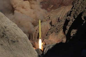 File - In this photo obtained from the Iranian Fars News Agency, a Qadr H long-range ballistic surface-to-surface missile is fired by Iran's Revolutionary Guard, during a maneuver, in an undisclosed location in Iran, Wednesday, March 9, 2016.